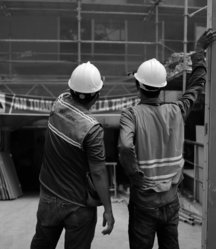 a-couple-of-men-wearing-hard-hats.jpg a couple of men wearing hard hats