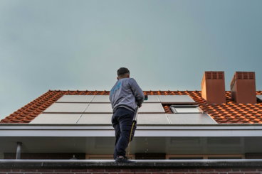a-man-standing-on-the-roof-of-a-building.jpg A man standing on the roof of a building