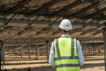 a-man-wearing-a-safety-vest-and-hard-hat.jpg A man wearing a safety vest and hard hat